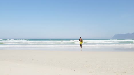 male surfer running with surfboard at beach 4k