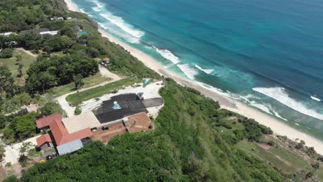 The-Ulu-Paragliding-Site-on-cliffs-of-Tropical-Bali-Island,-aerial