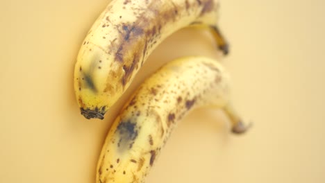 two overripe bananas on a light background
