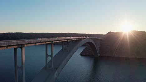 stunning sunset view of an arch bridge over the sea