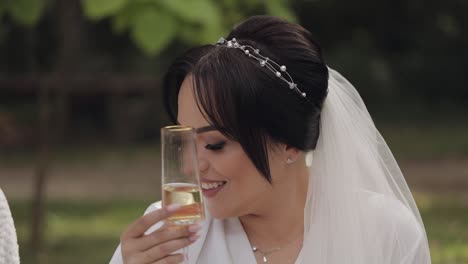 bride smiling and holding a champagne glass