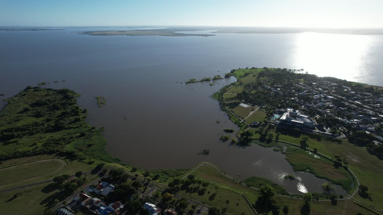 orbital drone around the main postcard of the city of Federacion, Argentina, a horseshoe on the edge of the dam