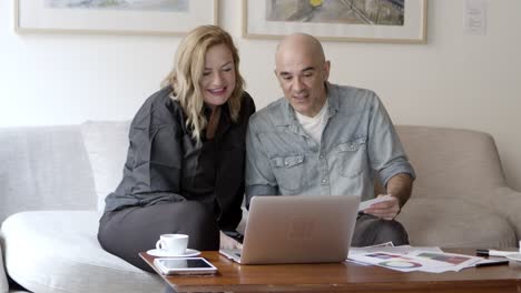 front view of happy couple looking at home project