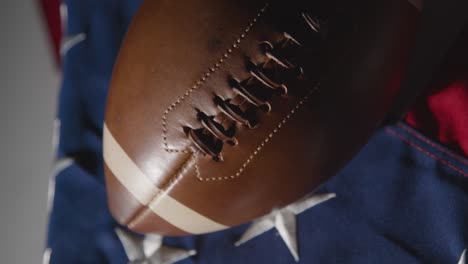 close up studio shot of american football on stars and stripes flag 9