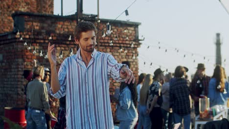 Young-Handsome-Man-Dancing-Cheerfully-At-The-Rooftop-Party-At-Daytime