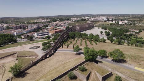 wide aerial pull-out of amoreira aqueduct in sunny elvas, portugal