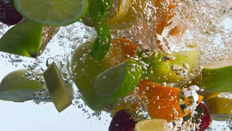 juicy fruits falling water in super slow motion. organic ingredients floating.