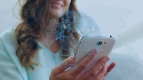 animation of digital globe spinning over woman using smartphone