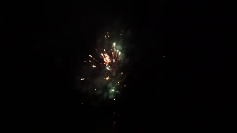 fireworks display at dark night sky in slow motion handheld blur