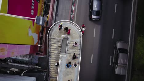 aerial view of city street with overpass and people