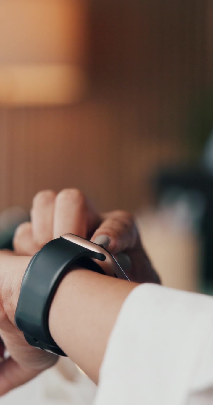 Woman Using Smartwatch in Indoor Setting