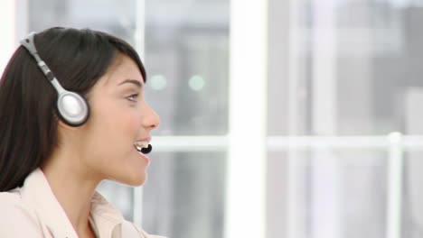 assertive businesswoman talking on headset