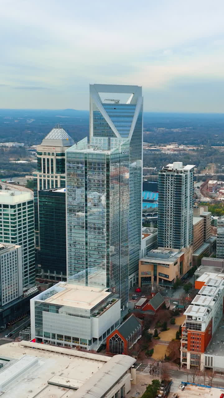 Charlotte, North Carolina, USA - January 05, 2024: Aerial panoramic view of the city center with tall skyscrapers of the financial district. Vertical video