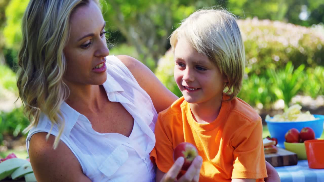 공원 4k에서 식사를 하는 동안 서로 상호 작용 하는 어머니 와 아들