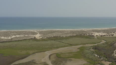 flying on the tranquil shore of armona island in algarve, portugal