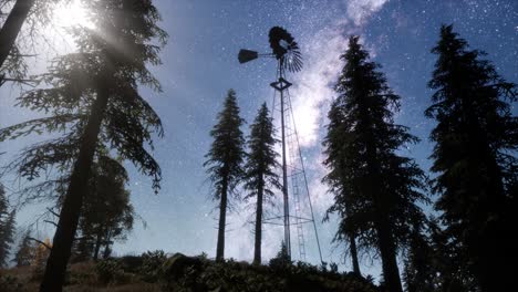 retro-windmill-in-mountain-forest-with-stars.-hyperlapse