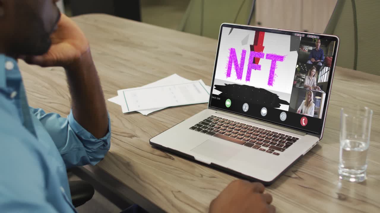 African american businessman using laptop for video call with diverse business colleagues