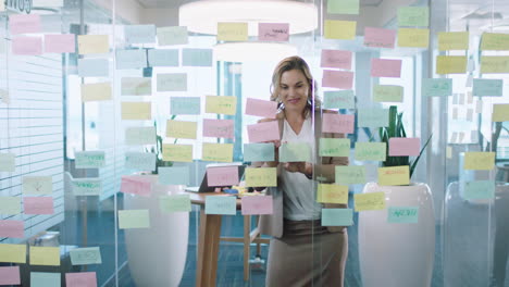 beautiful business woman using sticky notes brainstorming ideas planning strategy problem solving with creative mind map working on solution in office 4k