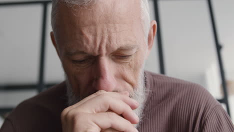 Close-Up-Of-An-Upset-Middle-Aged-Man-Worrying-And-Thinking-About-Something-While-Sitting-On-Sofa-At-Home-2