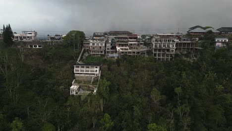 Road-and-buildings-crowd-tropical-volcano-rim-at-Mount-Batur,-Bali