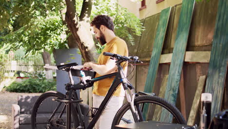 youthful man carrying bicycle toolbox