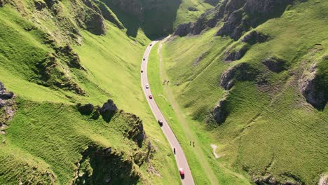 cars driving on winnats pass in peak district of derbyshire, united kingdom