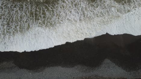 drone video of waves on a rocky beach