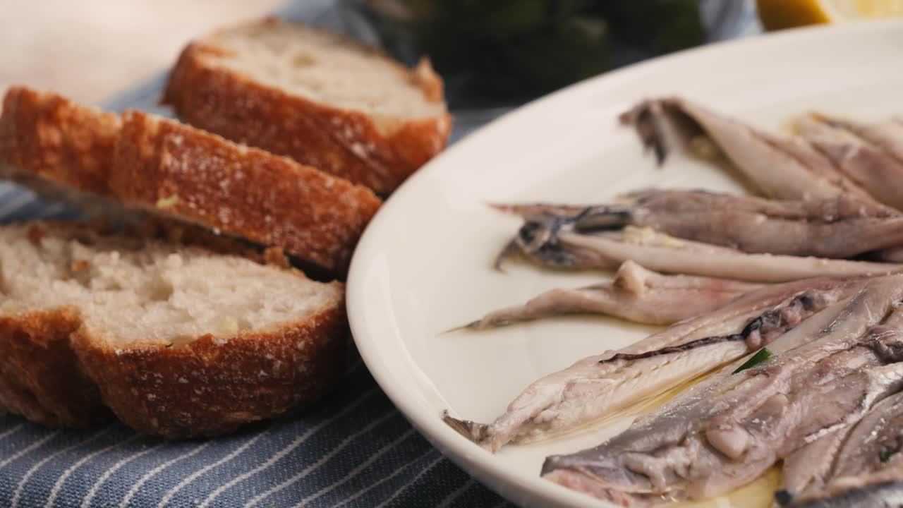 Fresh Sea sardines and Anchovy Fish and Mullus On Display On Ice On Market Store Shop. Seafood Fish Background, close up stand of small salty white fish.