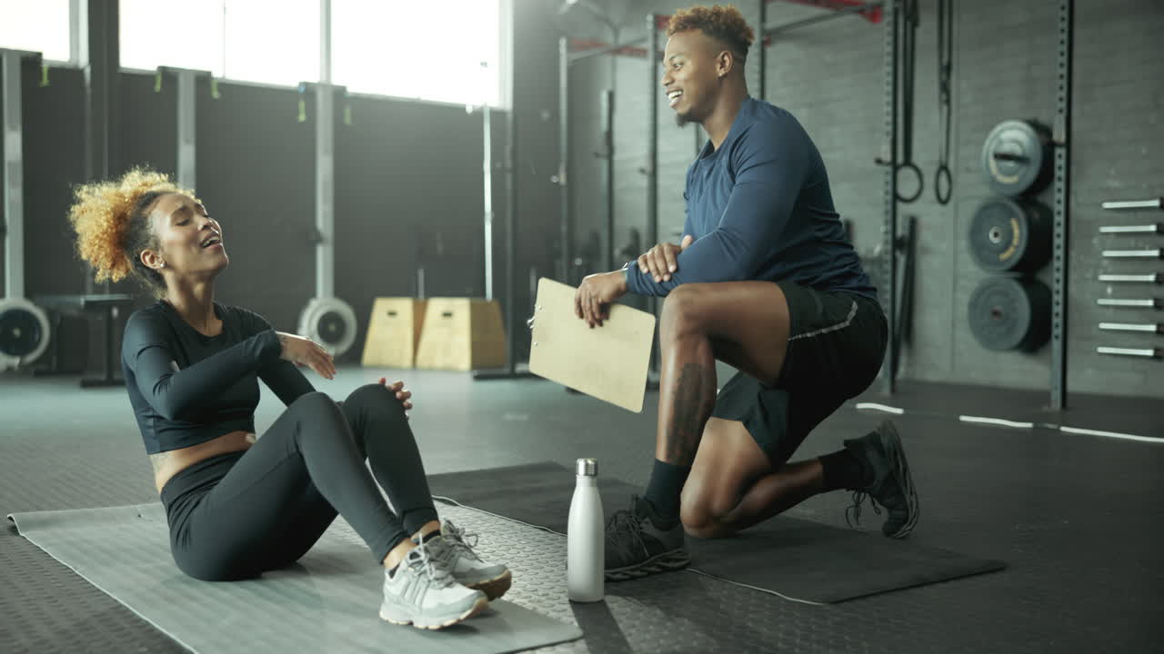 Personal trainer helping a woman at the gym