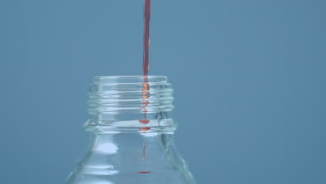 animation of red shapes over liquid pouring into bottle