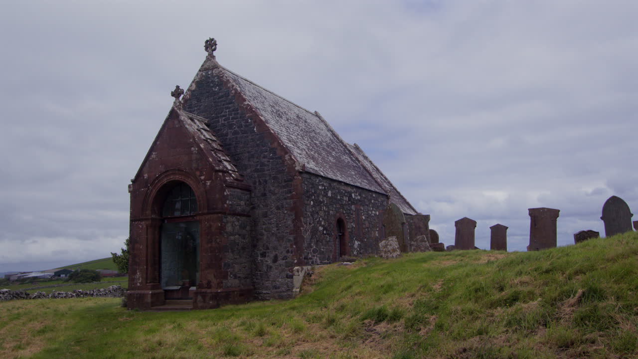 Wide shot of Kirkmadrine Chapel west door and graveyard