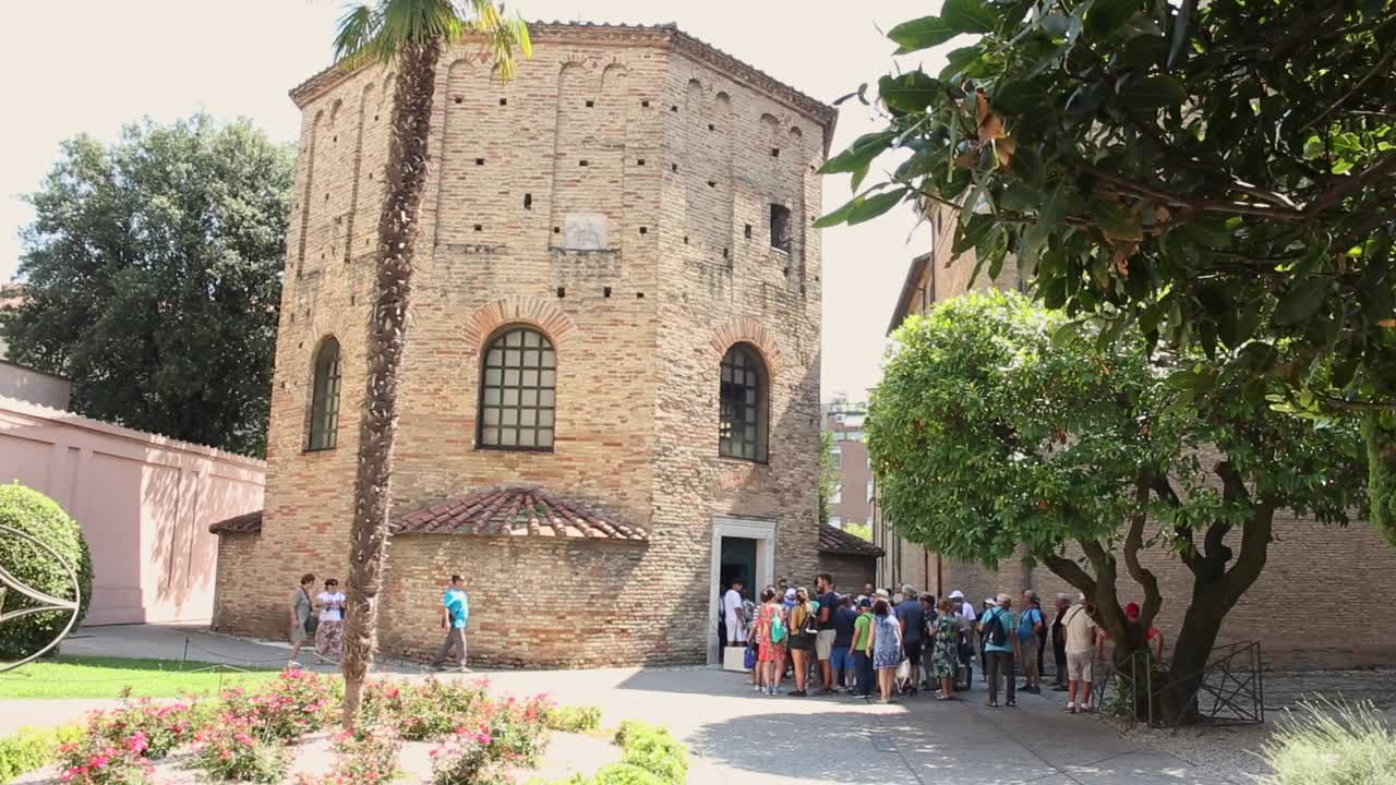 Crowd of people visiting Early Christian Baptistery of Neon in Ravenna ancient building