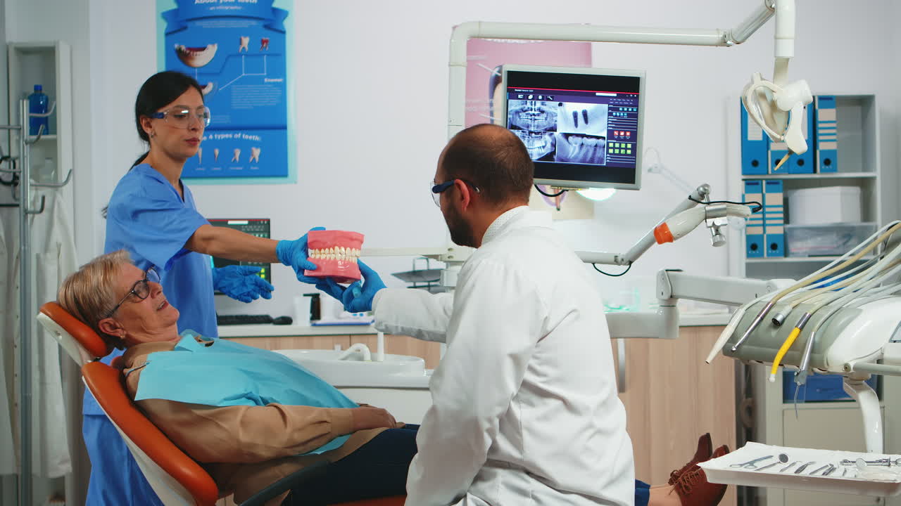 Stomatologist explaining dental hygiene using dental skeleton