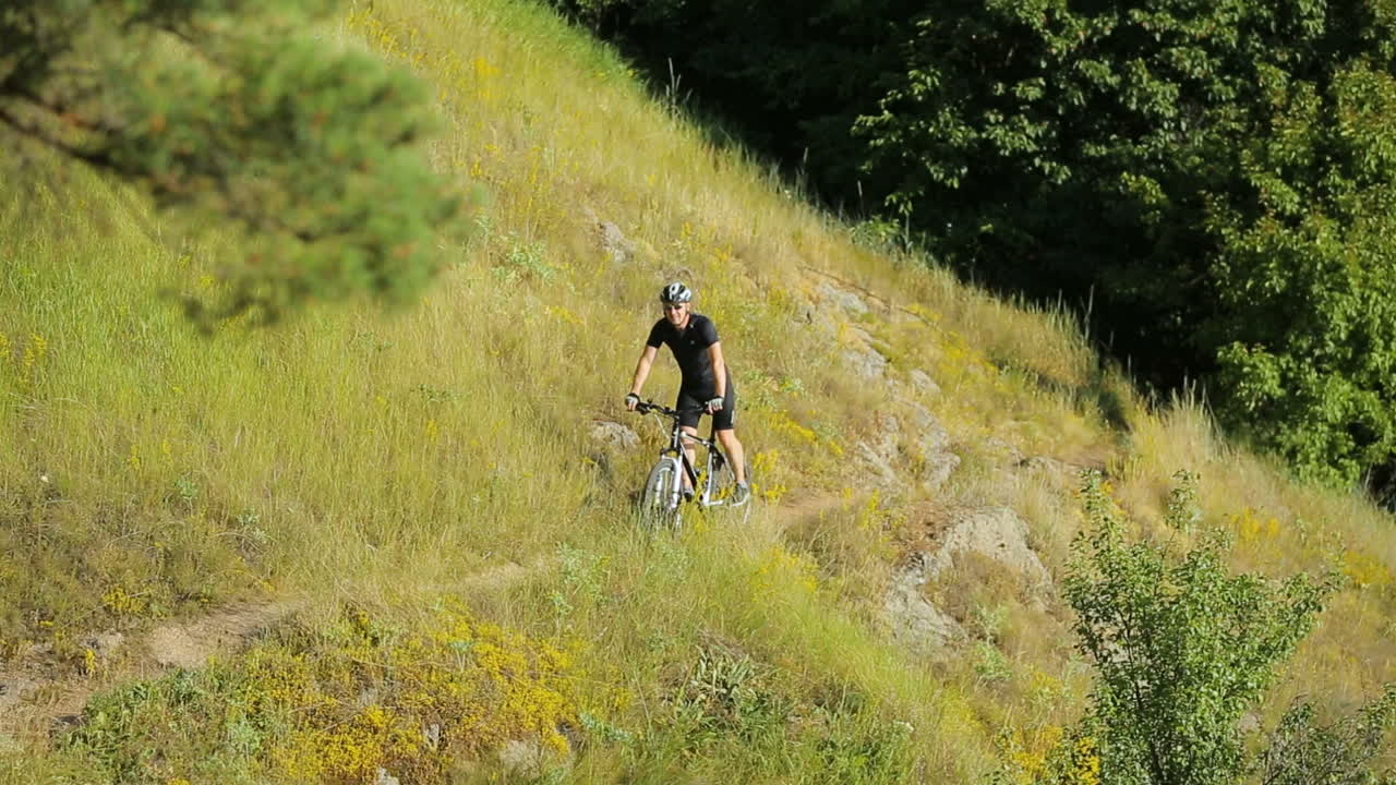 Cyclist Riding A Bike. Extreme mountain bike sport athlete man riding outdoors