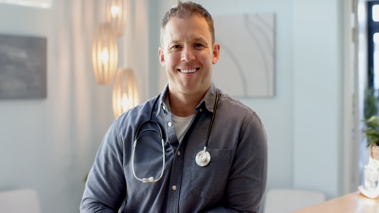 Smiling doctor with stethoscope in modern medical office, ready to assist patients