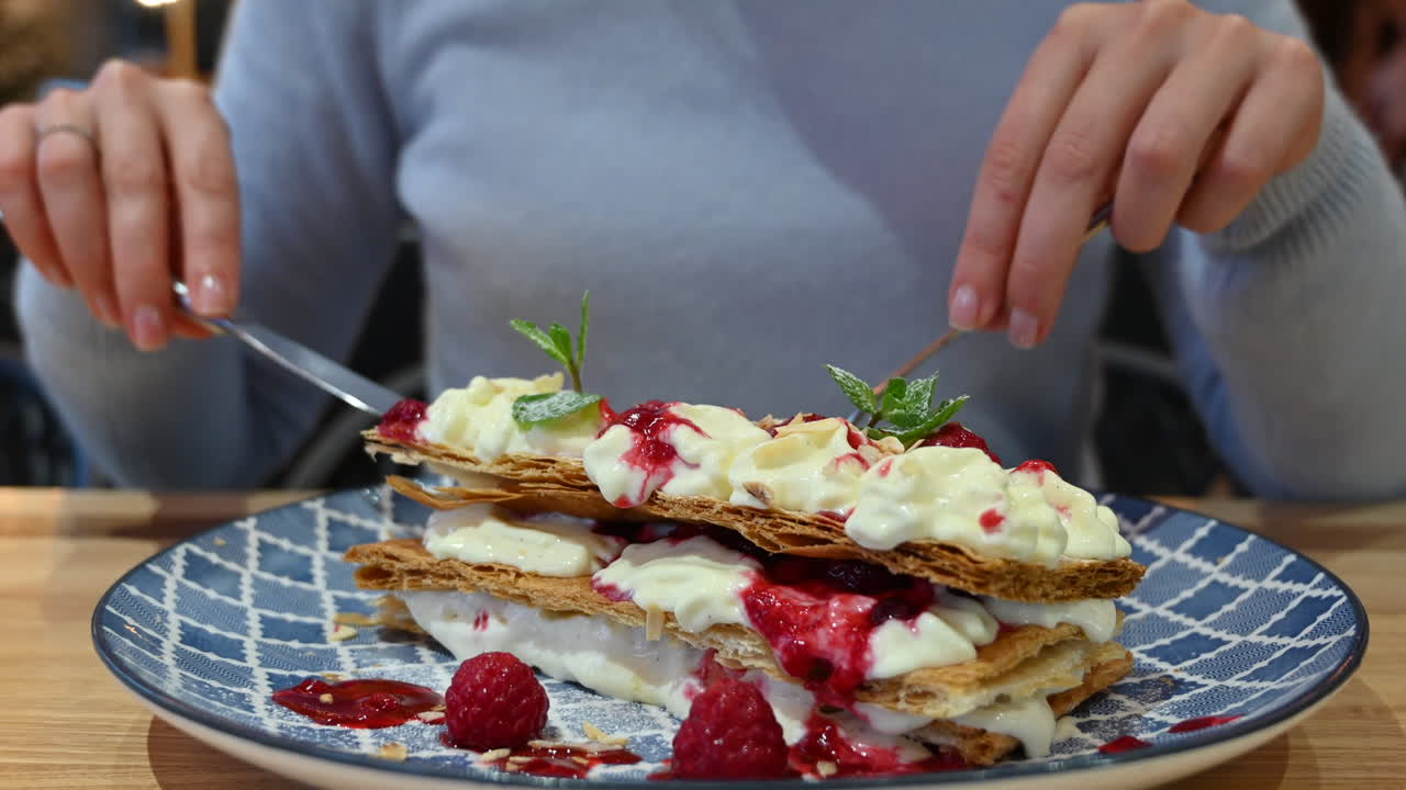 Woman eating millefeuille dessert at a restaurant