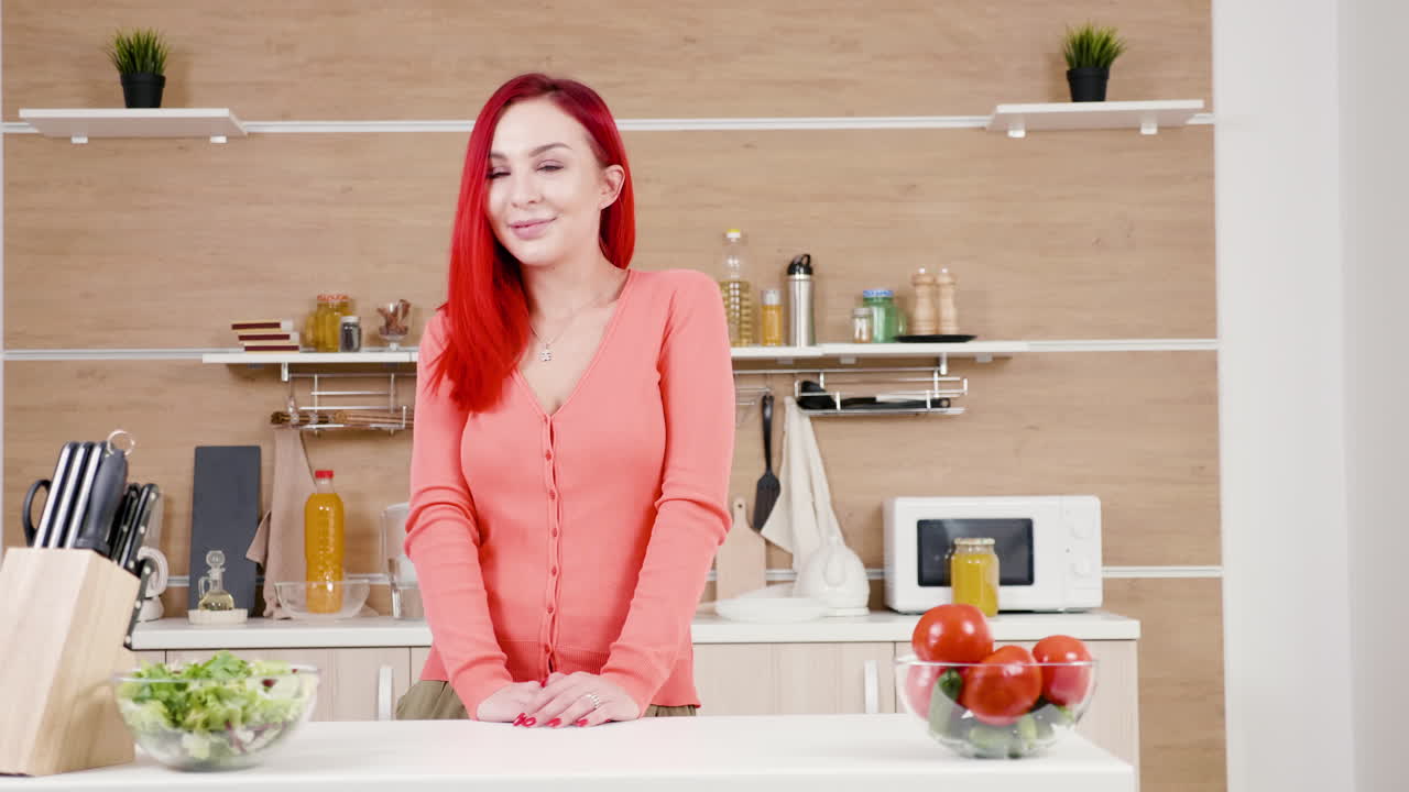 Woman in Kitchen with Salad and Tomatoes