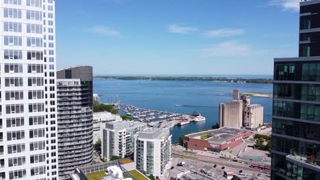 Aerial-shot-of-Toronto's-Billy-Bishop-airport-and-a-boating-harbor-on-Lake-Ontario