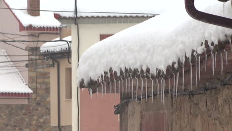 snowy roof with icicles