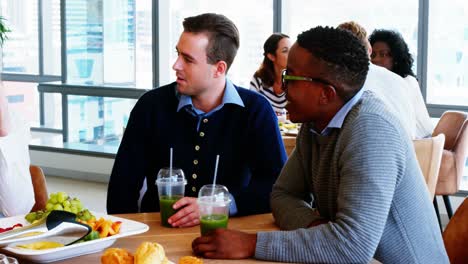 executives interacting with each other while having breakfast