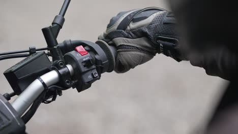 close up of rider reving to start his motorcycle engine