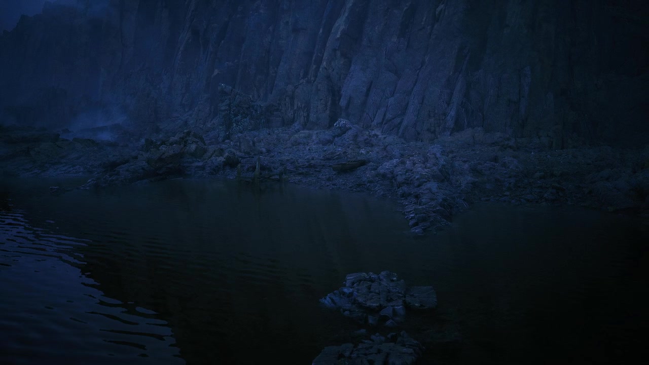 Quiet coastal panorama with moody blue hues and textured pebbles