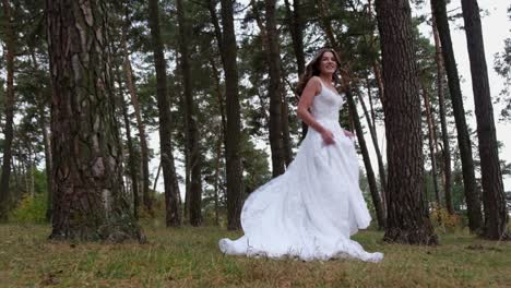 beautiful bride with long hair runs through the woods beautiful sunlight in the mountains the bride runs through the woods with curly hair in a lace dress