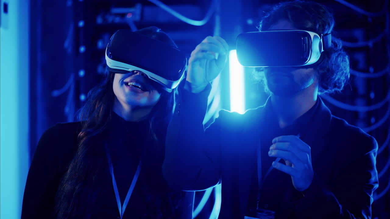 A man and a woman using Virtual Reality headsets in a server room
