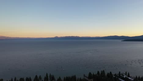 Peaceful-Water-Of-Lake-Tahoe-With-Sailing-Charter-Boats-During-Sunset-In-California,-United-States