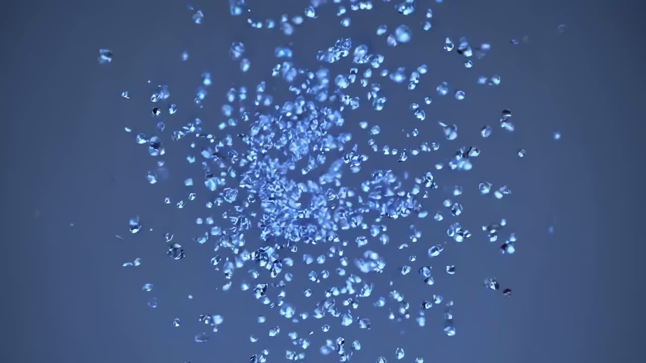 Aerial view of blue particles suspended in motion, creating a dynamic, abstract visual