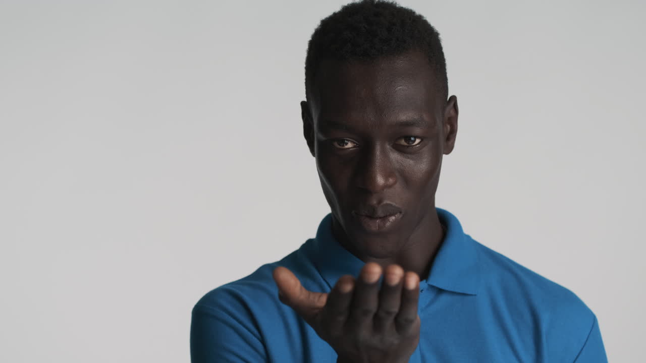 Seductive African american man on grey background.