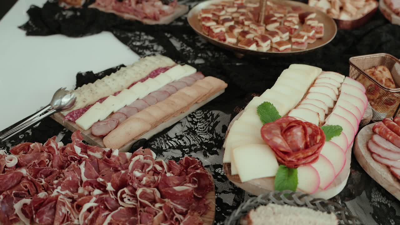 plated deli meats and cheese with decorative food styling on lace tablecloth