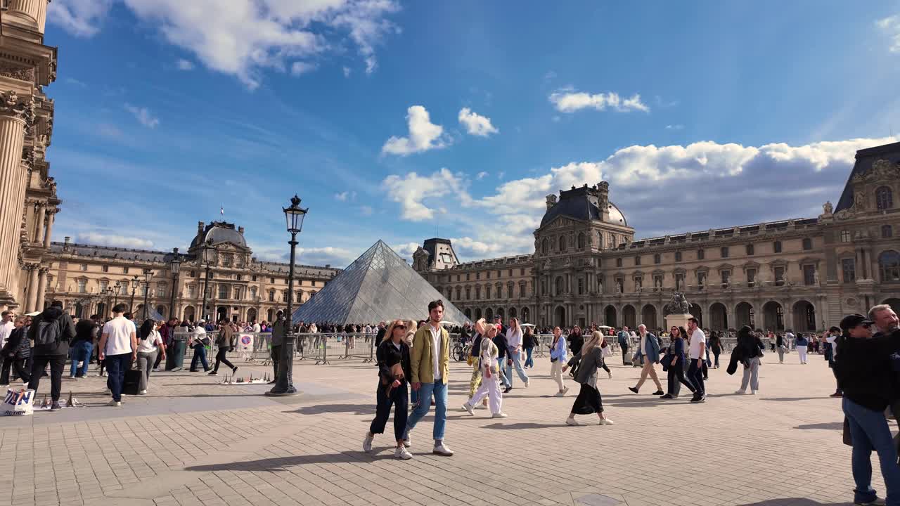 Louvre Pyramid museum square Paris France tourist attraction busy during the day