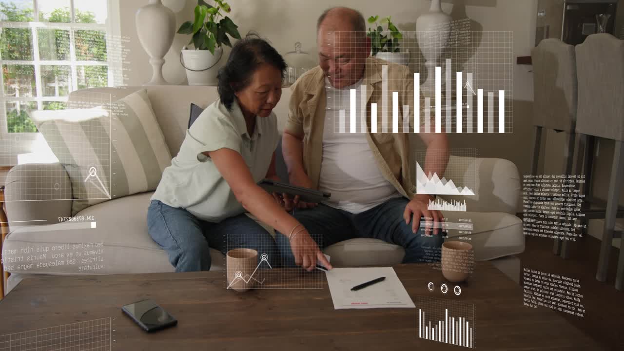 Couple tapping tablet in living room, generating animated finance charts and comparing data